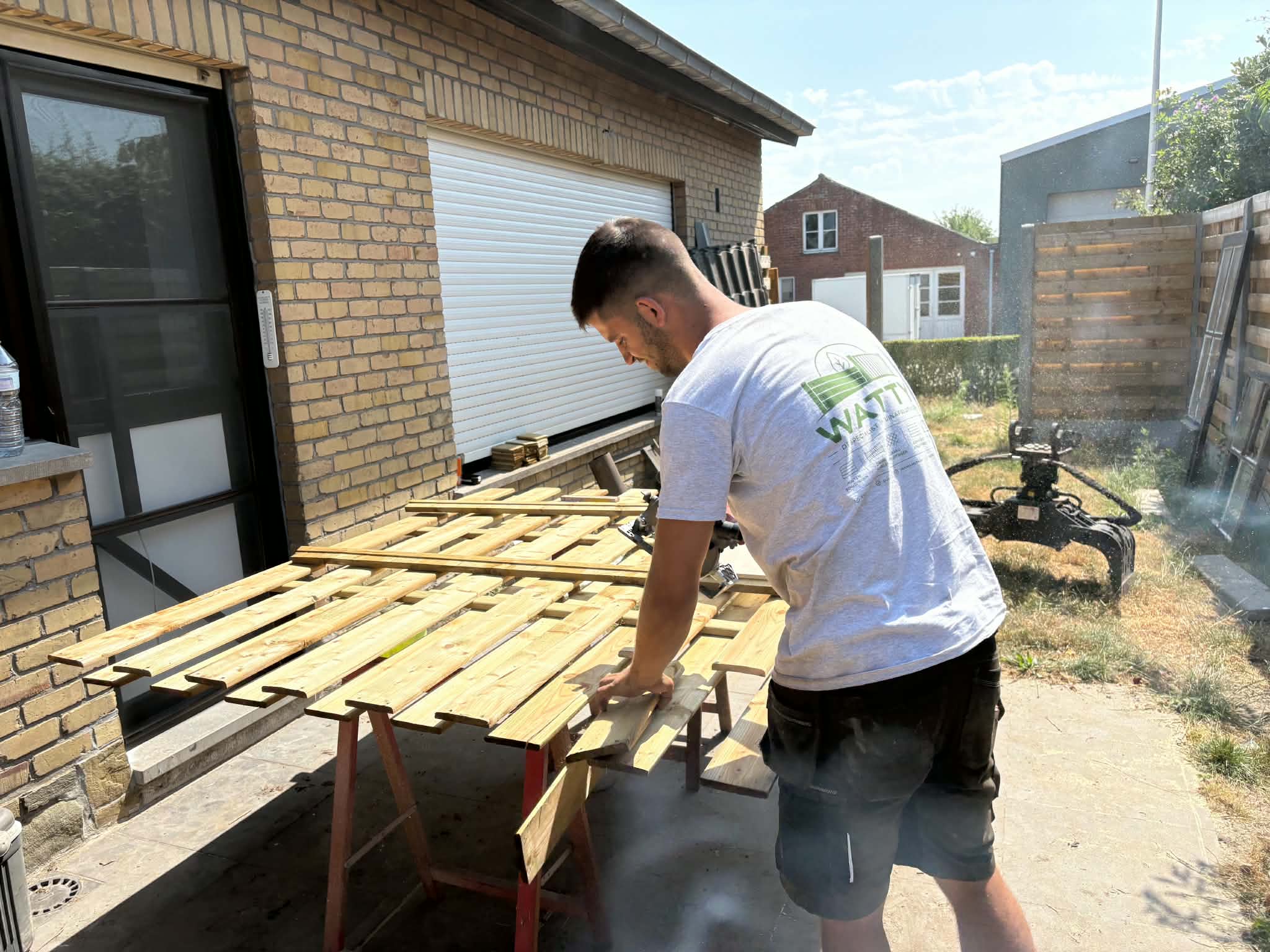 Lenny Watty bereidt houten onderdelen voor op een werf